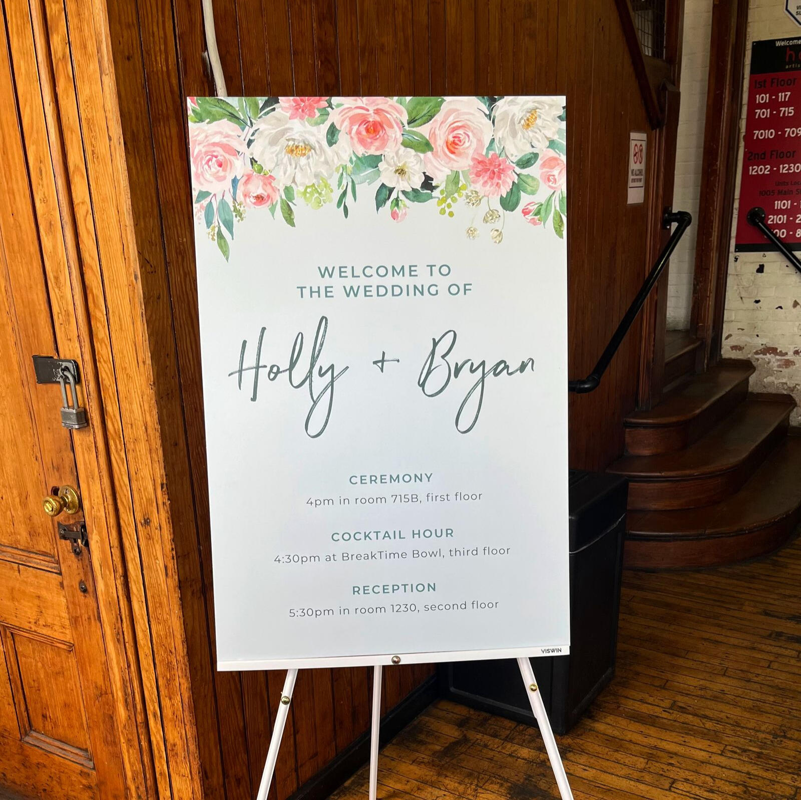 Wedding schedule sign reading, "Welcome to the wedding of Holly and Bryan," detailing timing of the events