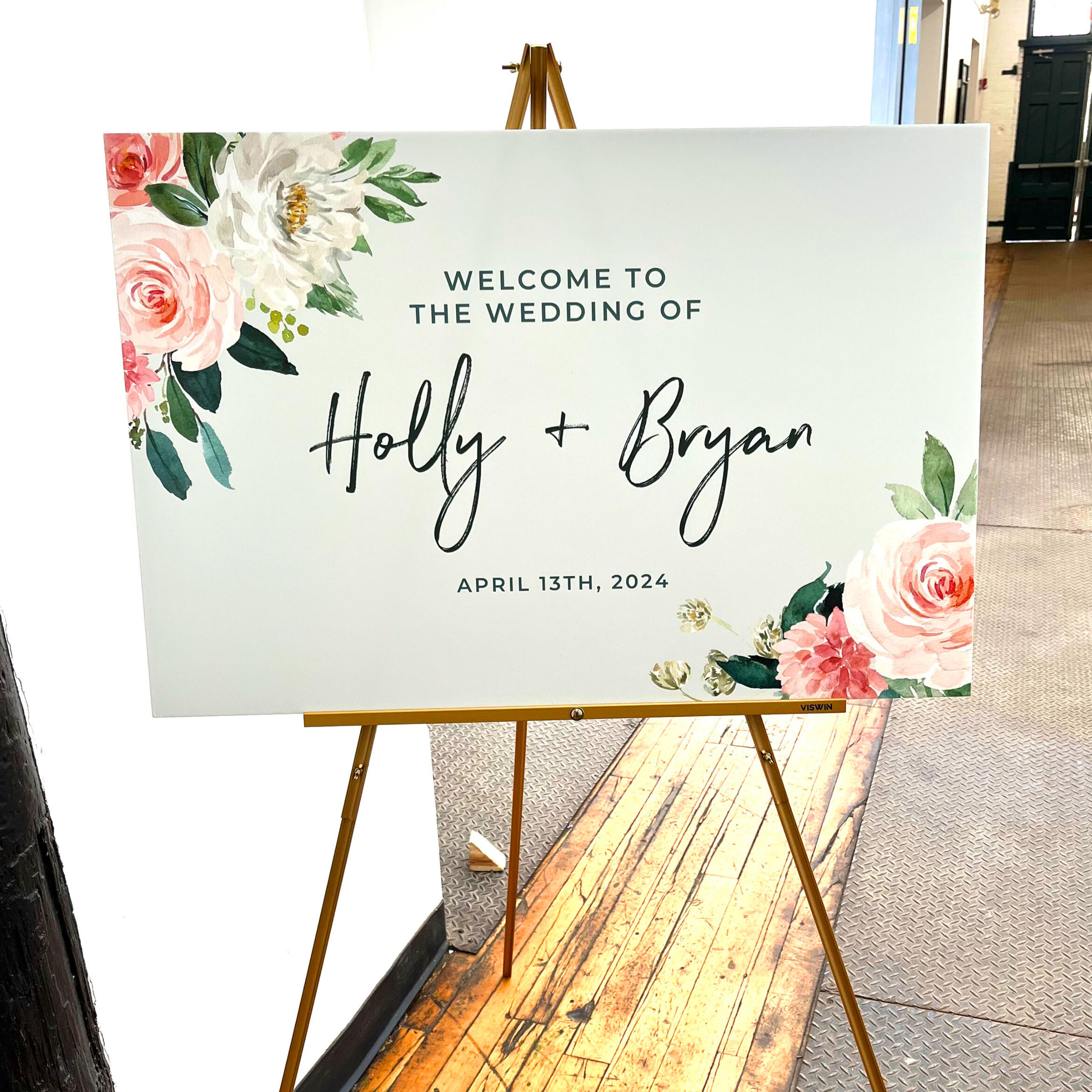 Floral wedding welcome sign reading, "Welcome to the wedding of Holly and Bryan"