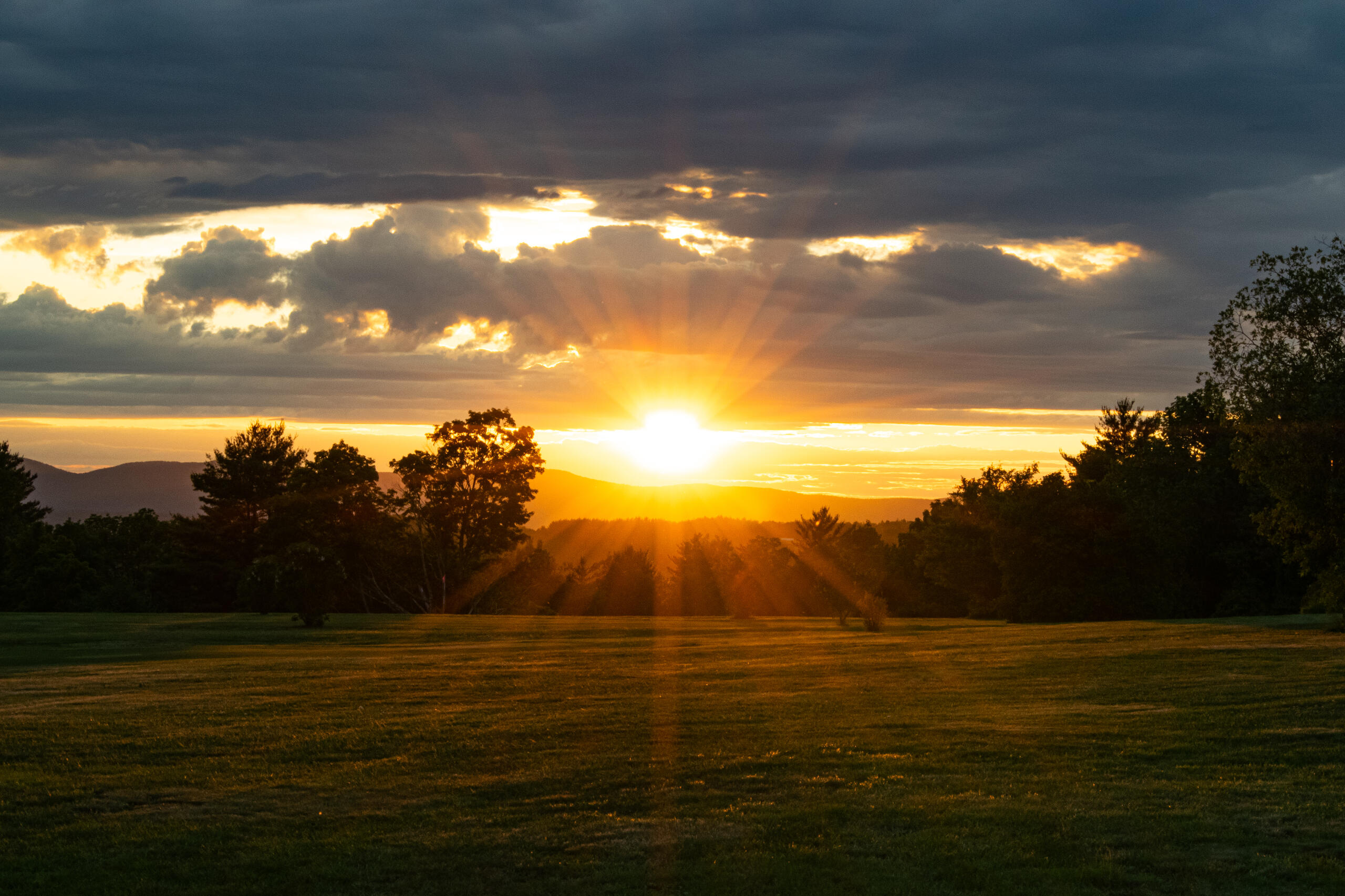 A photo of sunset behind mountains in New Hampshire