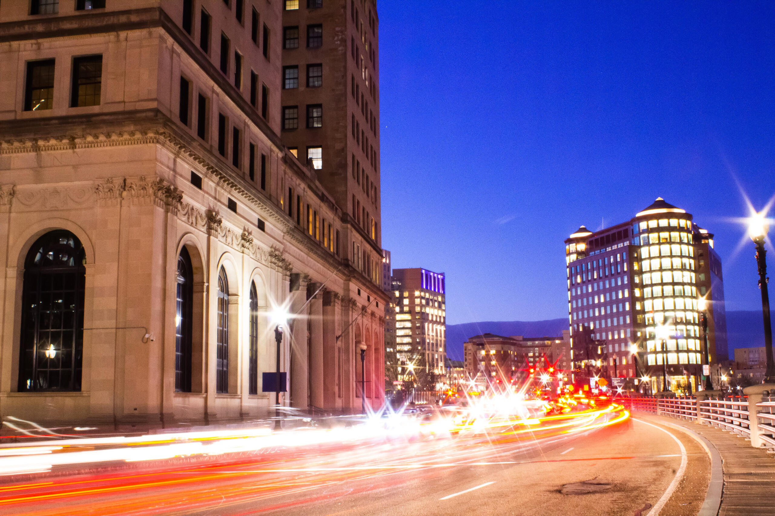Photograph of downtown Providence, Rhode Island with traffic lights trailing behind cars